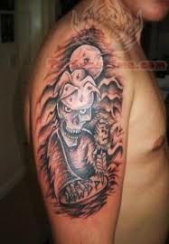 Skull Mask Tattoo On Bicep