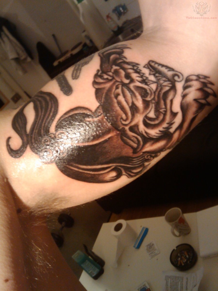 Foo Dog Tattoo On Muscles