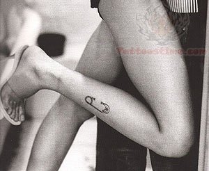 Safety Pin Tattoo On Girl Right Leg