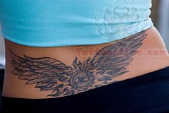 Winged Eye Tail Bone Tattoo