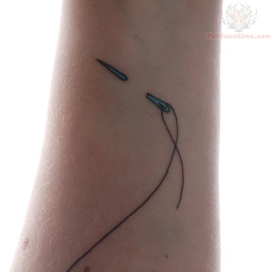 Thread And Needle Tattoo On Left Arm