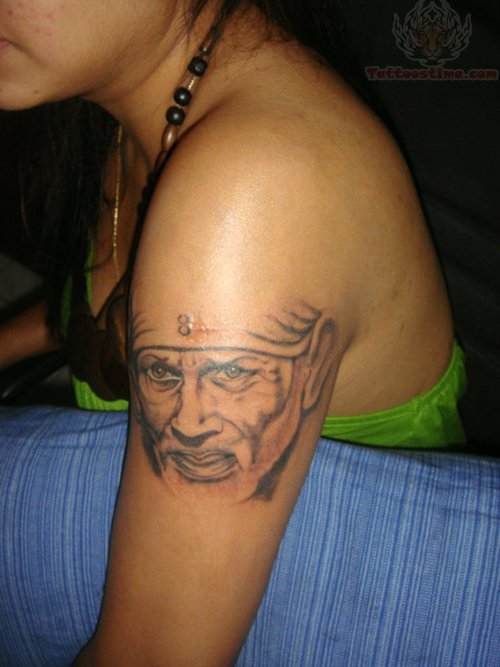 Grey ink Sai Baba Tattoo On Girl Bicep
