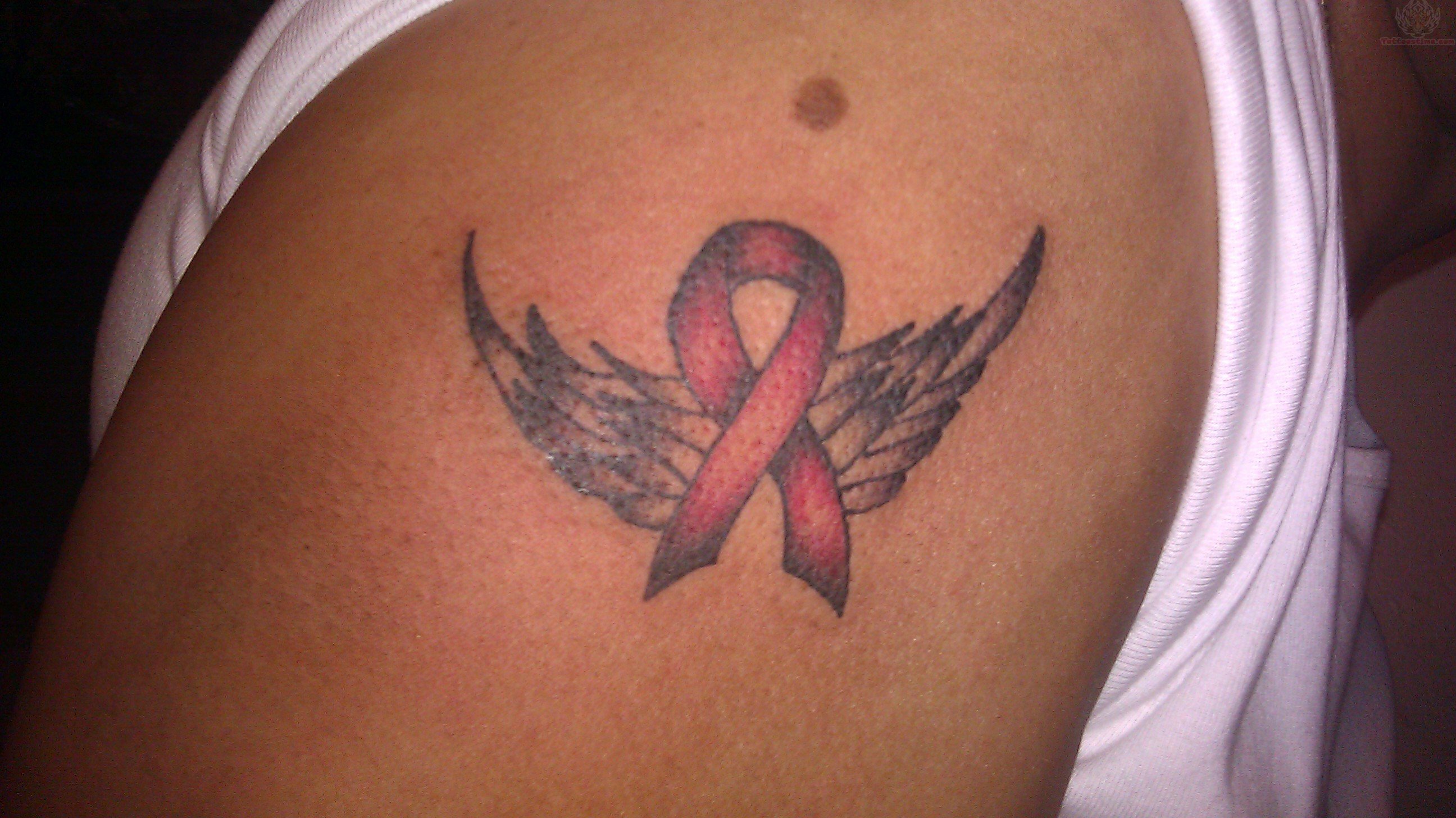 Winged Ribbon Tattoo On Left Shoulder