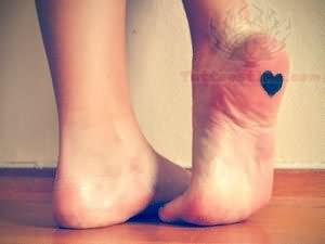 Tiny Black Heart Tattoo On Bottom  Of Heel
