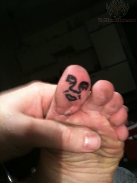 Weeping Face Tattoo On Bottom Of Toe