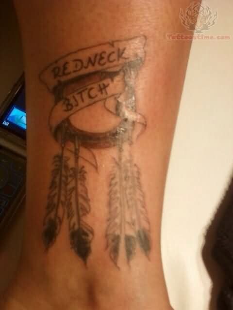 Grey Ink Horse Shoe And Feathers With Red Neck Bitch Banner Tattoo