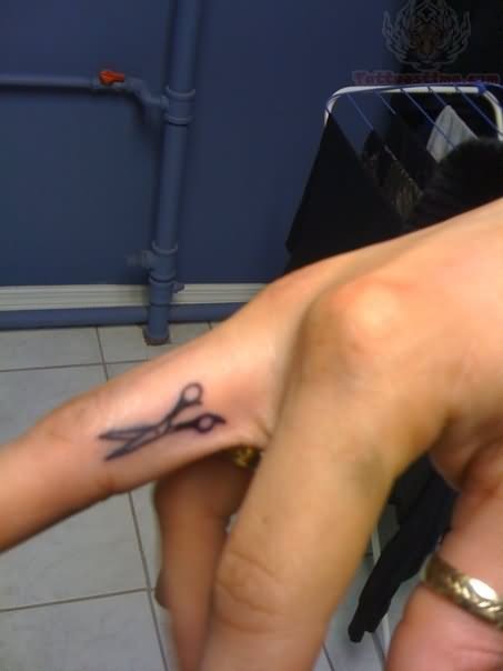 Small Scissor Tattoo On Middle Finger