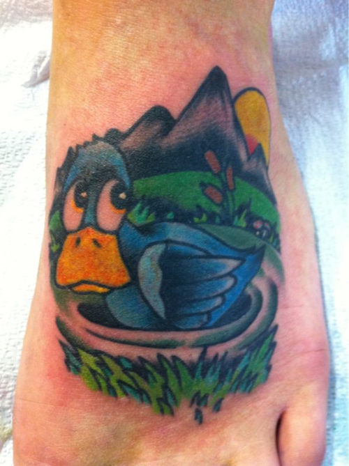 Yellow Beak Duck In Nest Tattoo On Left Foot