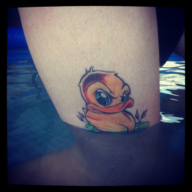 Yellow Ink Duck Tattoo On Leg