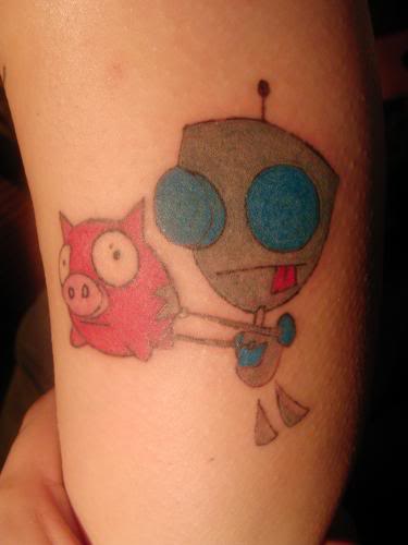 Zeme Cartoon Girl  And Red Ink Pig Tattoo On Bicep