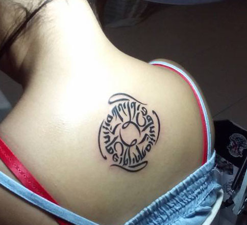 Graceful And Kindness Black Ink Tibetan Tattoo On Upperback