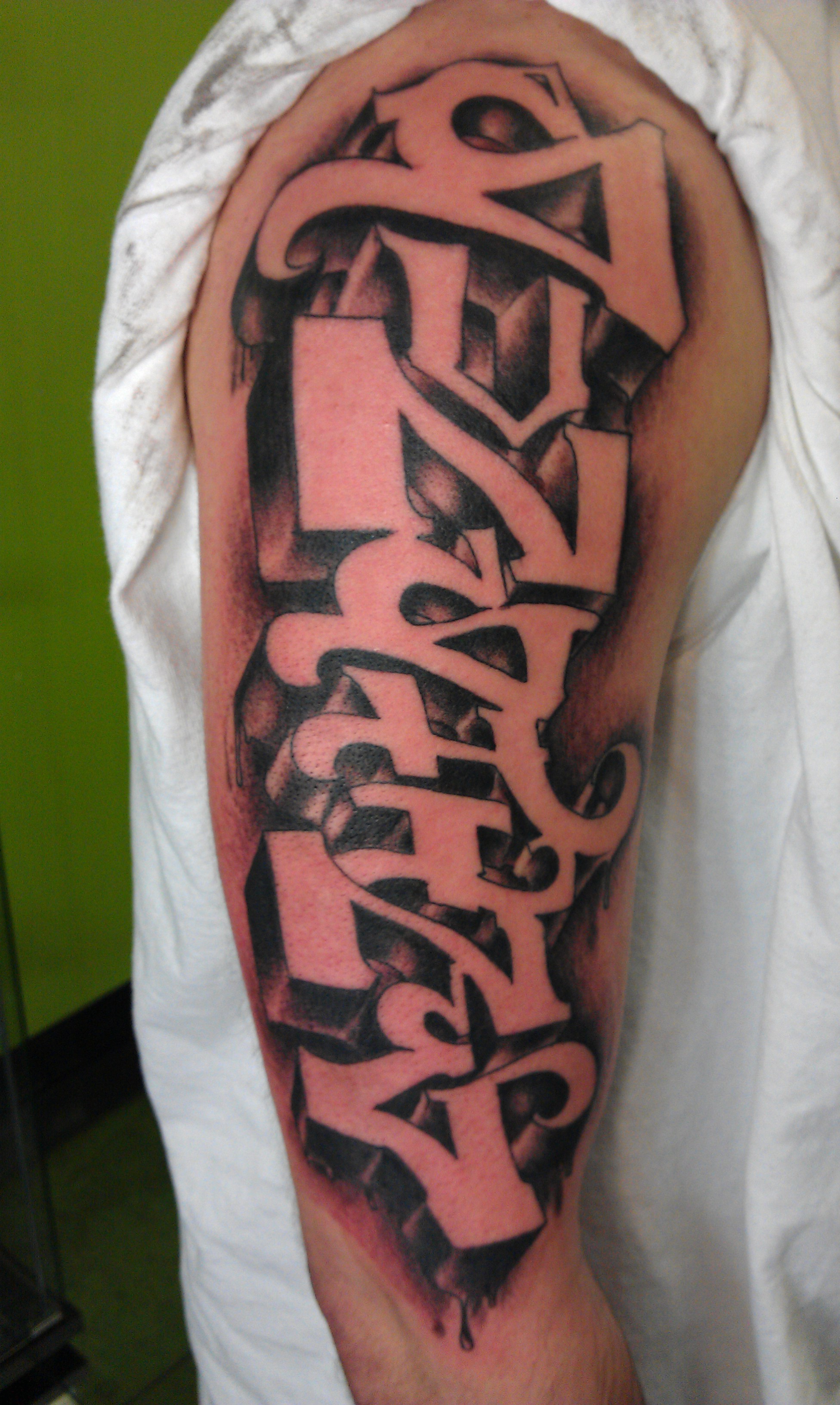 Grey Ink Graffiti Tattoo On Right Sleeve