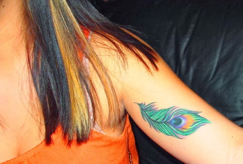Colored Peacock Feather Tattoo On Bicep