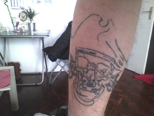 Grey Ink Pirate Skull Tattoo On Leg