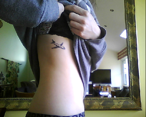 Small Airplane Tattoo On Girl Side Rib