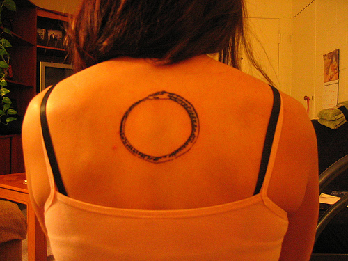 Stylish Ouroboros Tattoo On Girl Upperback