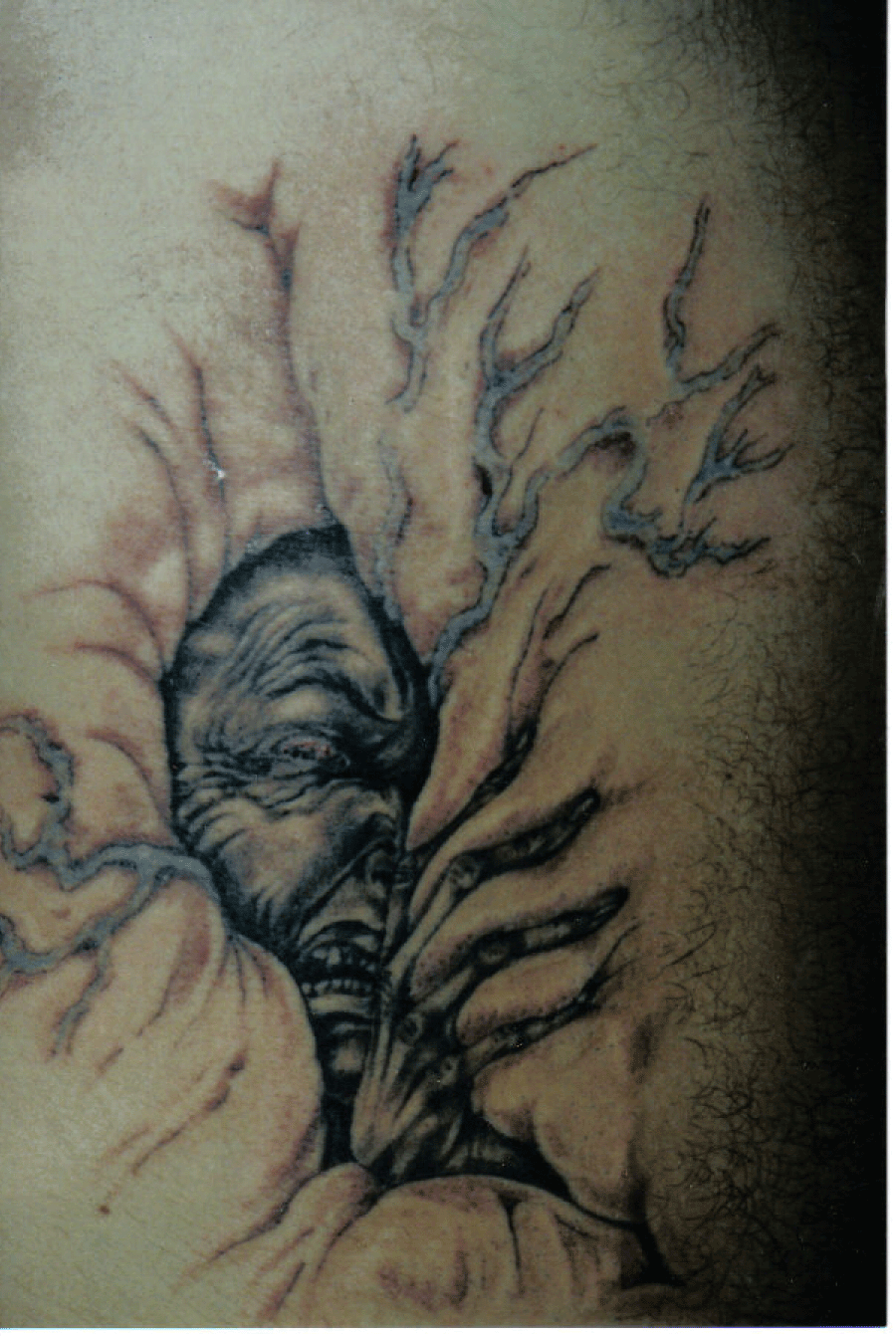 Ripped Skin Goblin Tattoo