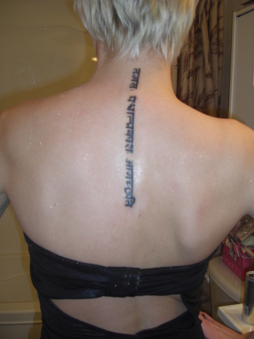 Spine Tattoo On Girl Upperback