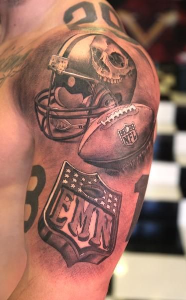 Grey Ink Football And Helmet Tattoo On Left Half Sleeve