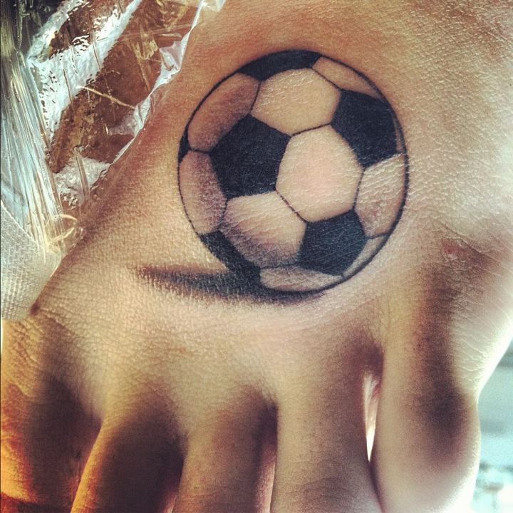 Grey Ink Football Tattoo On Left Foot