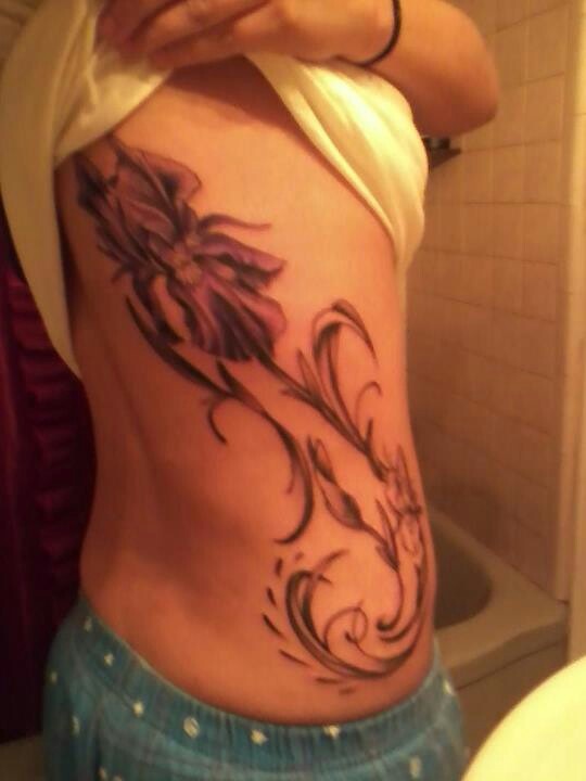 Grey Ink Iris Tattoo On Side Rib