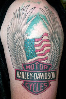 Winged Harley Tattoo On Left Shoulder