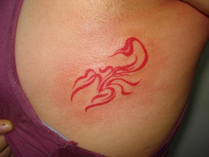 Red Ink Tribal Scorpio Tattoo On Right Back Shoulder
