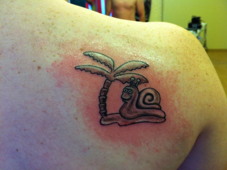 Small Snail And Palm Tree Tattoo On Right Back Shoulder
