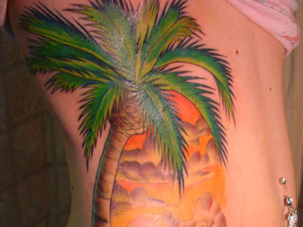 Sunset And Beach Palm Tree Tattoo On Side Rib