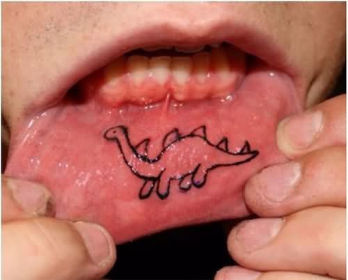Outline Dinosaur Tattoo On Lip
