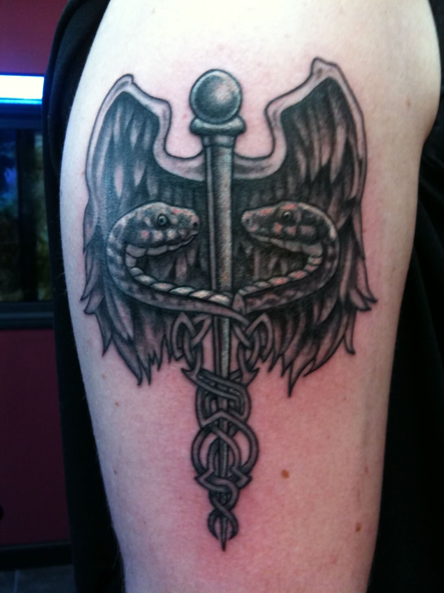 Grey Ink Medical Symbol Tattoo On Right Shoulder