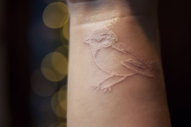 White Ink Bird Tattoo On Wrist