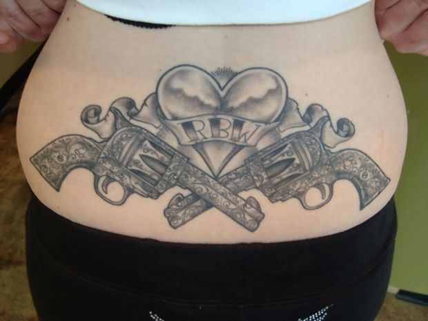 Lowerback Guns And Heart Weapons Tattoo