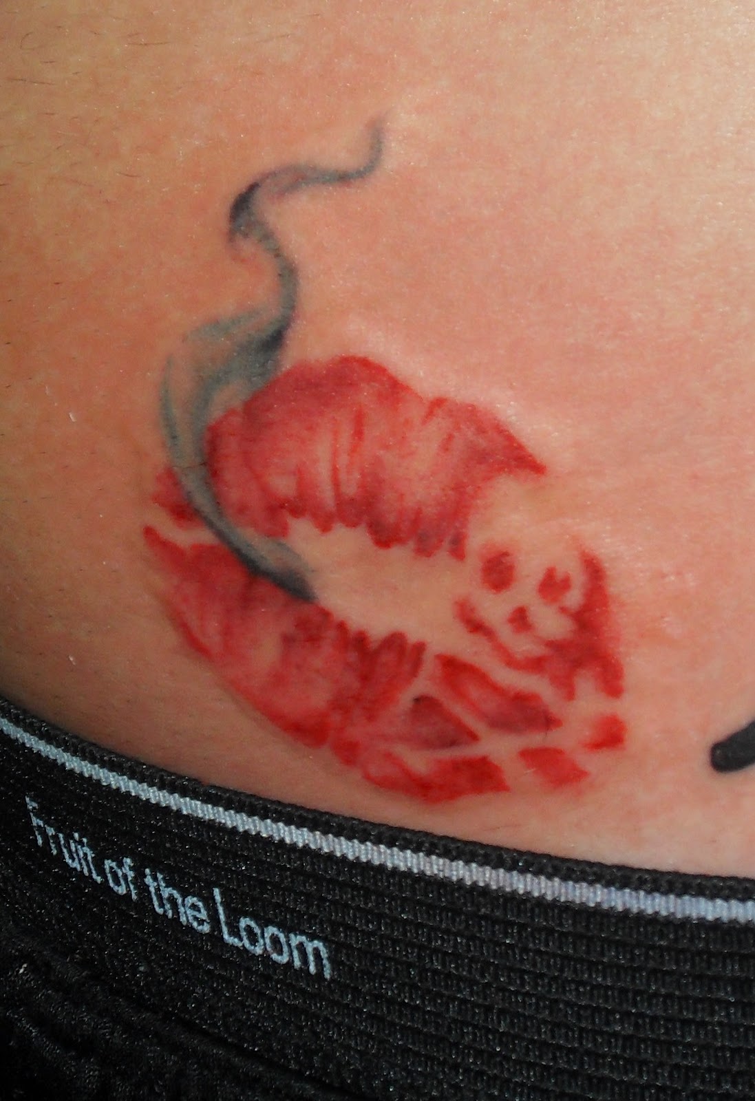 Smoke Pirate Lip Tattoo On Lower Back