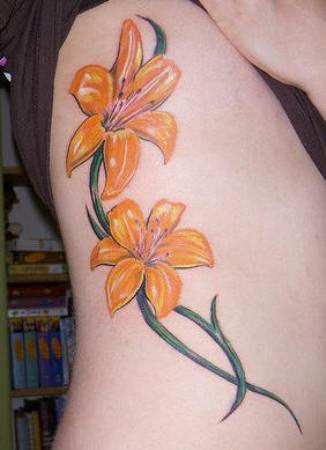 Yellow Lily Tattoos On Rib Cage For Women