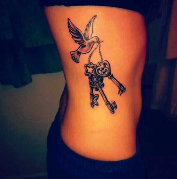 Bird Flying With Keys Tattoo On Rib Side