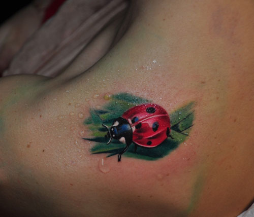 Ladybug On Green Leaf Tattoo On Upper Shoulder