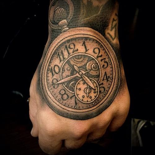 Nice Grey Ink Clock Tattoo On Left Hand
