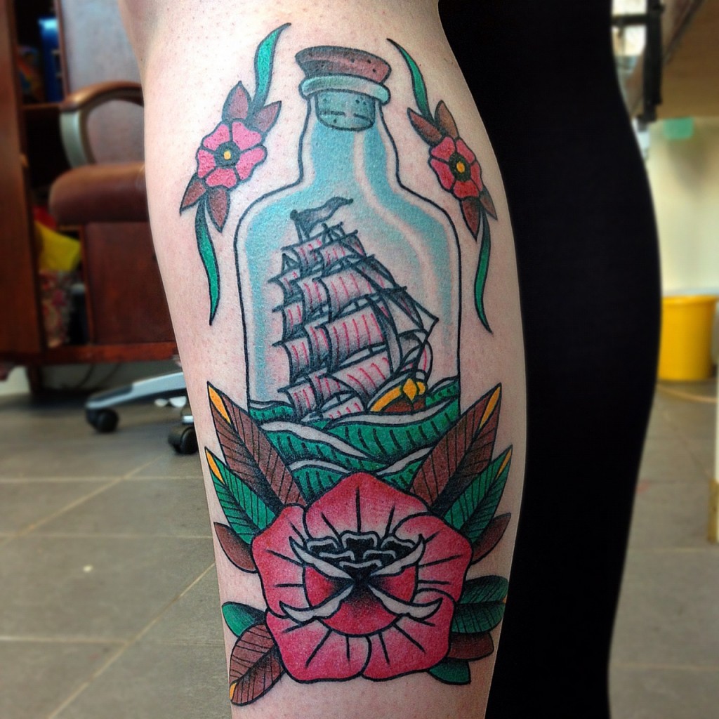 Royal Ship In Bottle Tattoo With Flowers On Leg