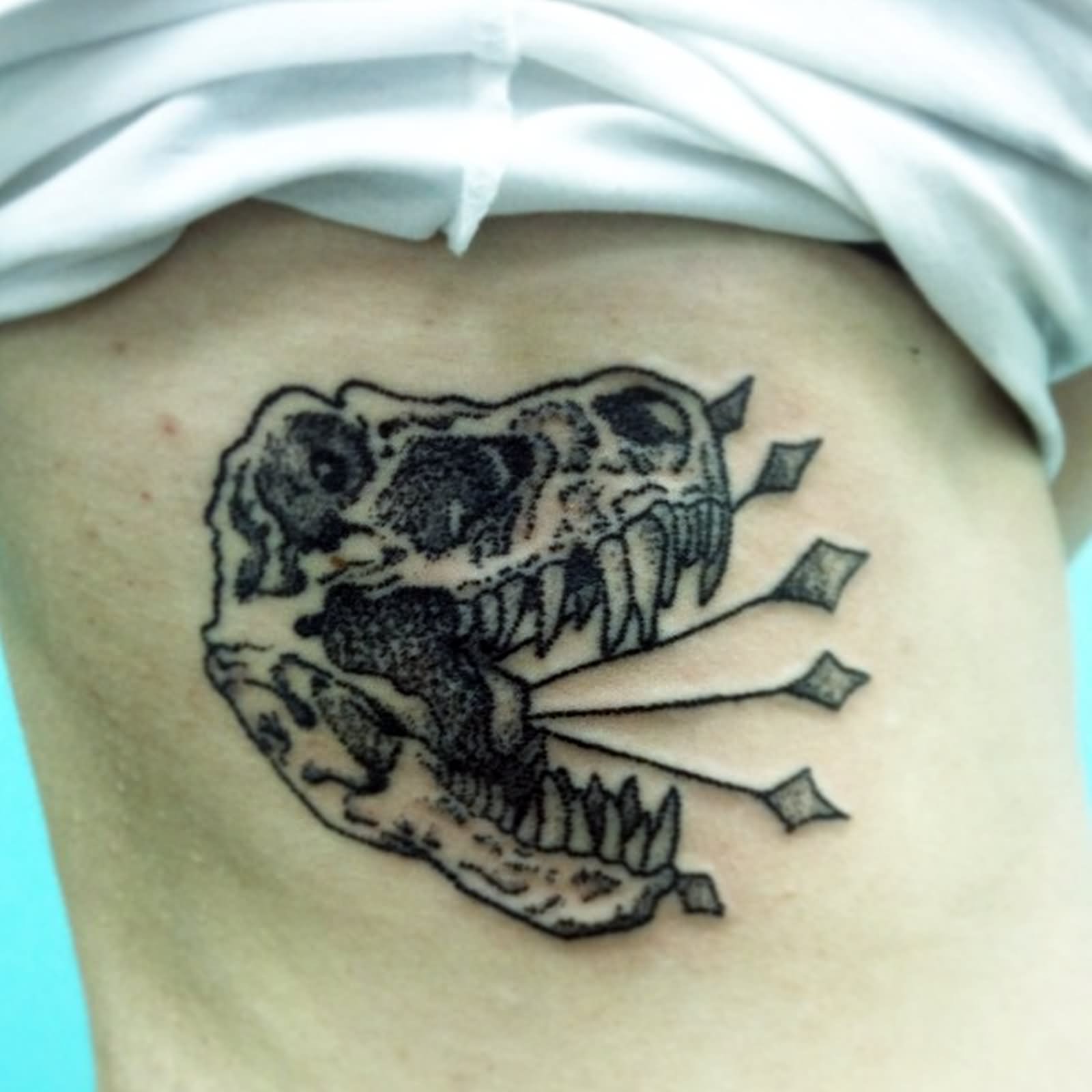 Hand Poked Dragon Skull Tattoo On Side Rib