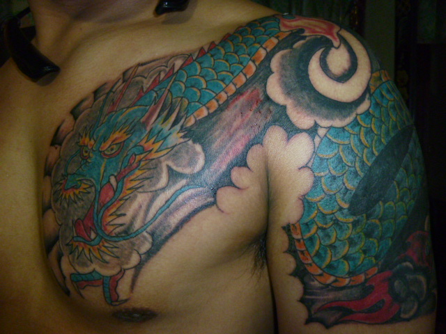 Colorful Dragon Tattoo On Chest And Shoulder