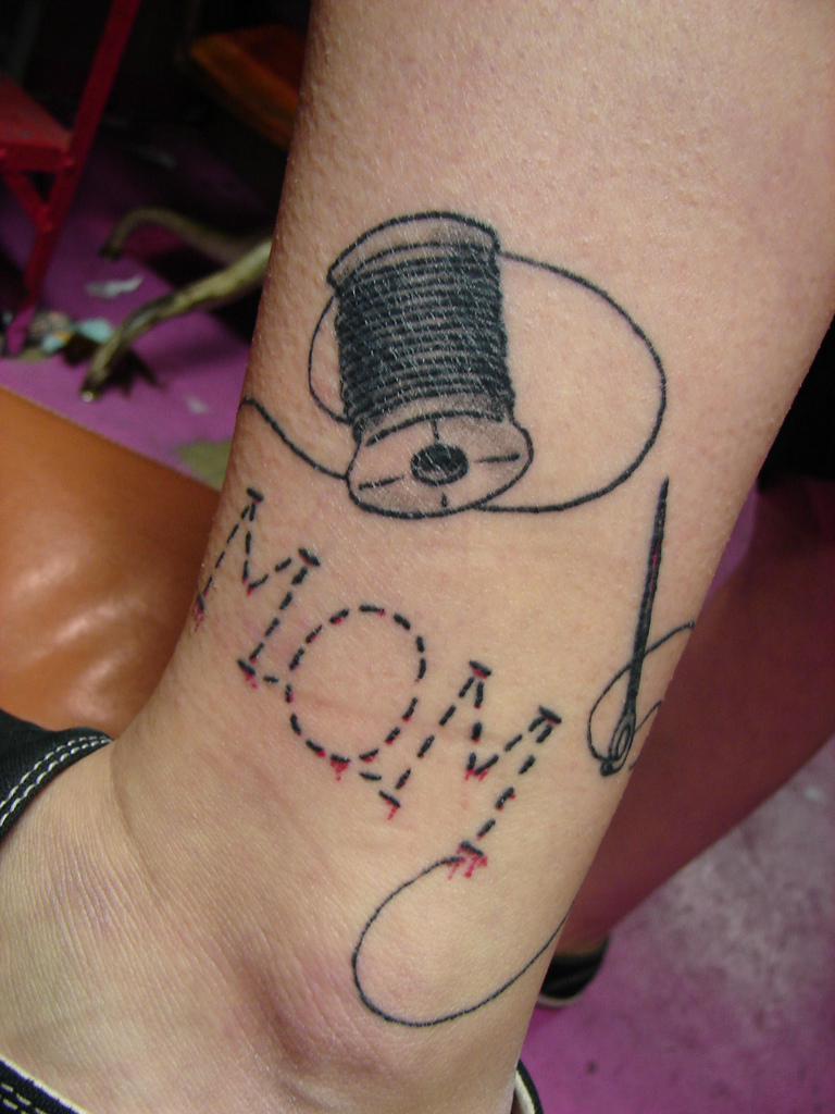 Sewing Tattoo On Girl Leg
