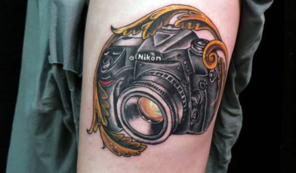 Nikon Camera Tattoo On Left Bicep