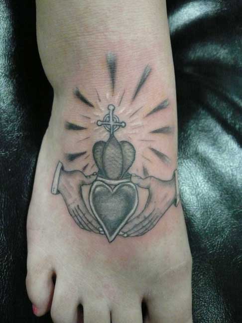 Grey Ink Claddagh Tattoo On Right Foot