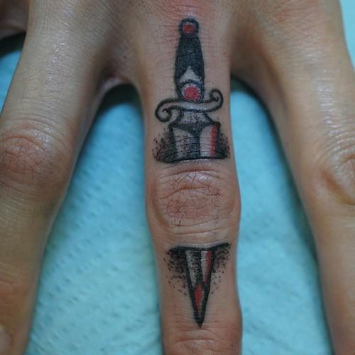Ripped Skin Dagger Tattoo On Finger