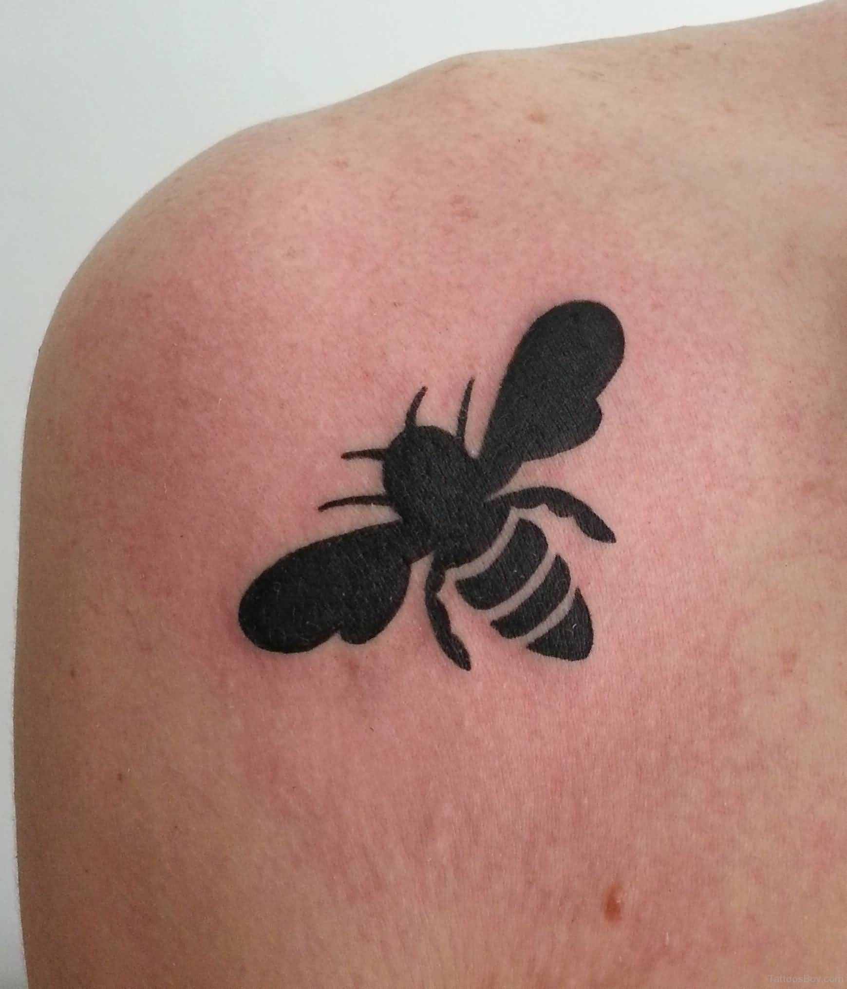 Black Silhouette Bee Tattoo On Back Shoulder